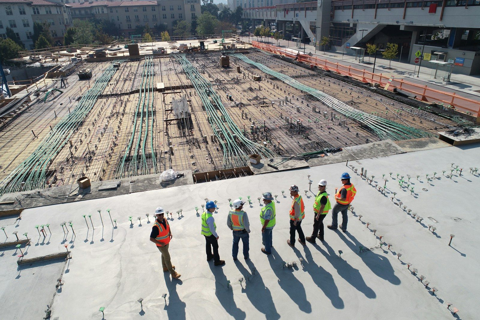 Construction team working on active residential building site with safety equipment