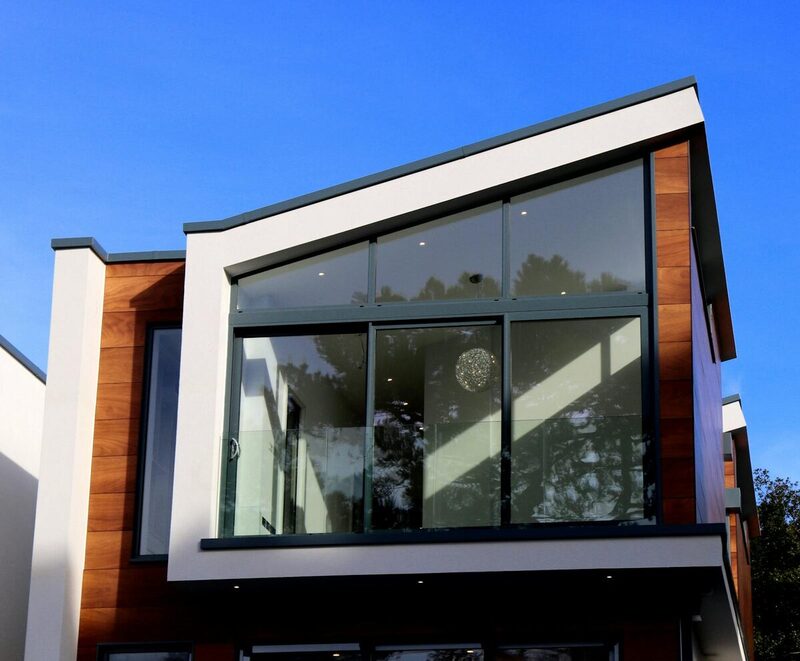 Modern JADU addition with wood cladding and large glass windows
